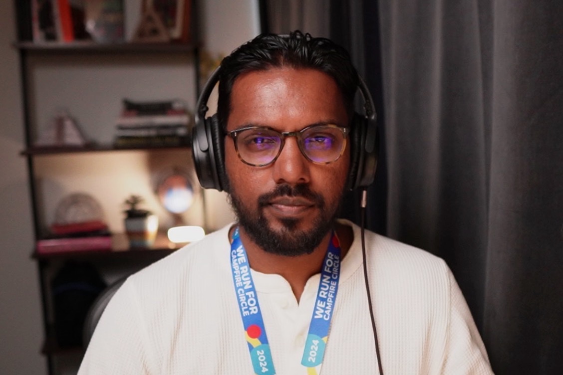 Christopher Balkaran recording a conversation while wearing headphones